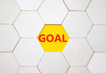 Goal symbol. Concept word Goal on wooden comb puzzle. Beautiful yellow background. Business and Goal...