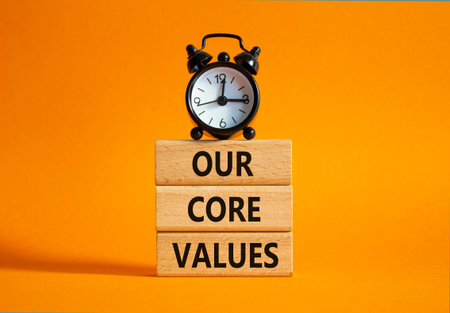 Core values symbol. Concept words Core values on wooden blocks. Beautiful orange background with alarm clock. Business and Core values concept. Copy space.の写真素材