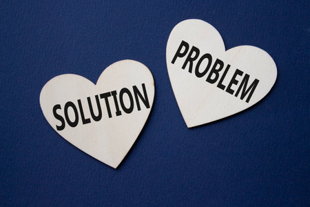 Solution vs Problem symbol. Concept word Solution vs Problem on wooden hearts. Beautiful deep blue background. Business and Solution vs Problem concept. Copy spaceの写真素材