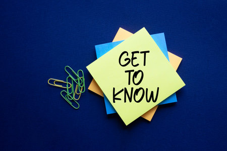 Get to Know symbol. Sticky Notes with words Get to Know. Beautiful deep blue background. Business...