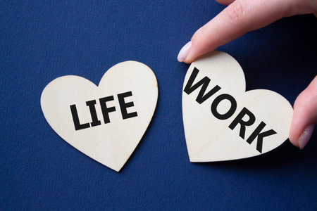 Life or Work symbol. Concept word Life or Work on wooden hearts. Businessman hand. Beautiful deep...