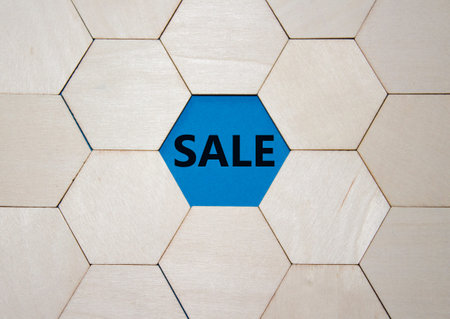 Sale symbol. Concept word Sale on wooden comb puzzle. Beautiful blue background. Business and Sale...