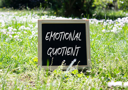 Emotional Quotient symbol. Concept word Emotional Quotient on chalk blackboard. Beautiful meadow...