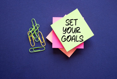 Set your Goals symbol. Sticky notes with Concept words Set your Goals. Beautiful deep blue...