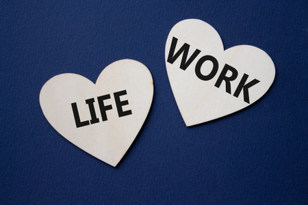 Life or Work symbol. Concept word Life or Work on wooden hearts. Beautiful deep blue background....