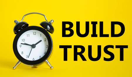Build trust symbol. Beautiful yellow background with alarm clock. Business and Build trust concept....