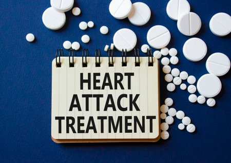 Heart Attack Treatment symbol. Concept word Heart Attack Treatment on notebook. Beautiful deep blue background with pills. Medicine and Heart Attack Treatment concept. Copy spaceの写真素材