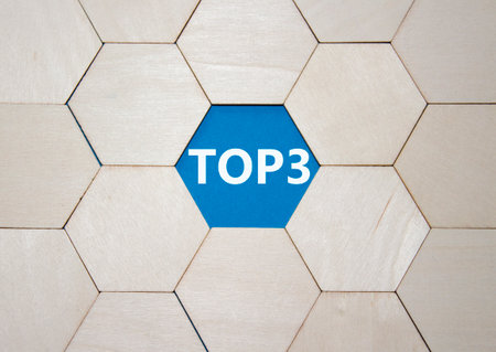 Top 3 symbol. Concept word Top 3 on wooden comb puzzle. Beautiful blue background. Business and Top 3 concept. Copy space.の写真素材