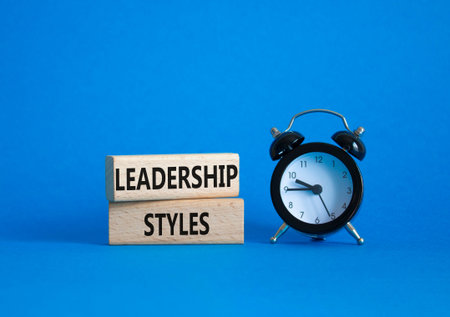 Leadership Styles symbol. Concept word Leadership Styles on wooden blocks. Beautiful blue background...