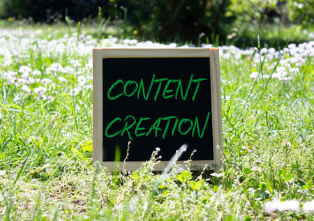 Content creation symbol. Concept word Content creation on chalk blackboard. Beautiful meadow...