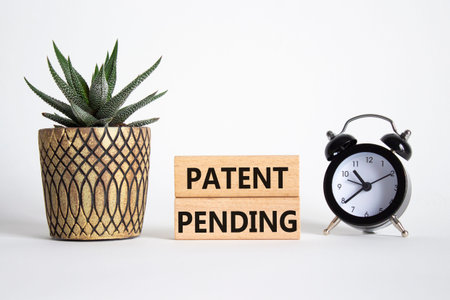Patent Pending symbol. Wooden blocks with words Patent Pending. Beautiful white background with...
