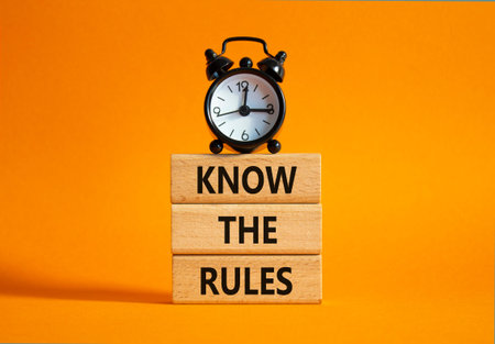 Know the rules symbol. Wooden blocks with words Know the rules. Beautiful orange background with...