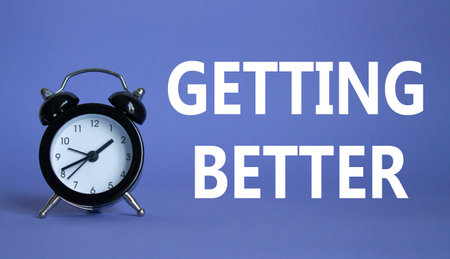 Getting better symbol. Beautiful purple background with alarm clock. Business and Getting better concept. Copy space.の写真素材