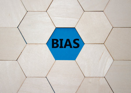 Bias symbol. Concept word Bias on wooden comb puzzle. Beautiful blue background. Business and Bias concept. Copy space.の写真素材