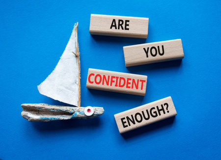 Confidence symbol. Wooden blocks with words Are you confident enough. Beautiful blue background with...
