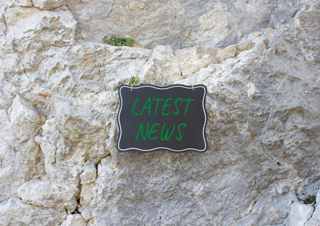 Latest News symbol. Stone wall with words Latest News. Beautiful stone background. Business and...
