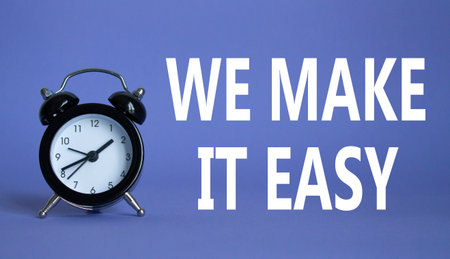 We make it easy symbol. Beautiful purple background with alarm clock with words We make it easy. Business concept. Copy space.の写真素材