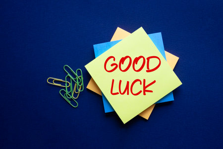 Good luck symbol. Good luck on sticky note. Beautiful deep blue background. Business and Good luck concept. Copy space.の写真素材