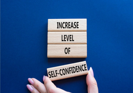 Increase level of self-confidence symbol. Wooden blocks with words increase level of self-confidence. Beautiful deep blue background. Copy space.の写真素材