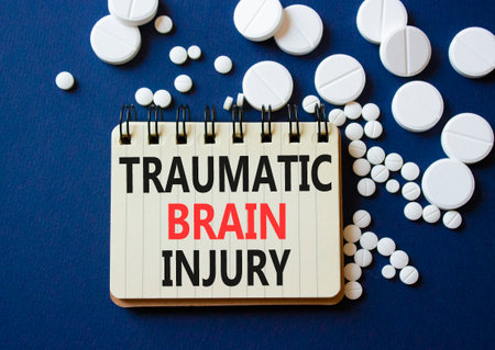Traumatic Brain Injury symbol. Concept words Traumatic Brain Injury on notebook. Beautiful deep blue low background with pills. Healthcare and Traumatic Brain Injury concept. Copy space.の写真素材