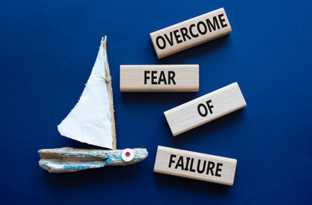 Fear of failure symbol. Concept words Overcome Fear of failure on wooden blocks. Beautiful deep blue...