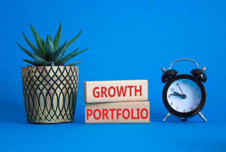 Growth Portfolio symbol. Concept word Growth Portfolio on wooden blocks. Beautiful blue background...
