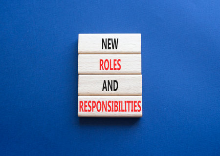 New roles and responsibilities symbol. Wooden blocks with words New roles and responsibilities. Beautiful deep blue background. Business concept. Copy space.の写真素材