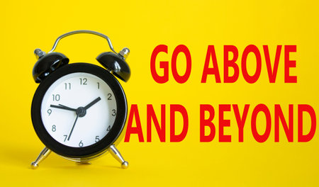 Go above and beyond symbol. Beautiful yellow background with alarm clock. Business and Go above and...