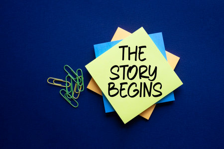 The Story Begins symbol. Sticky notes with words The Story Begins. Beautiful deep blue background. Business and The Story Begins concept. Copy space.の写真素材