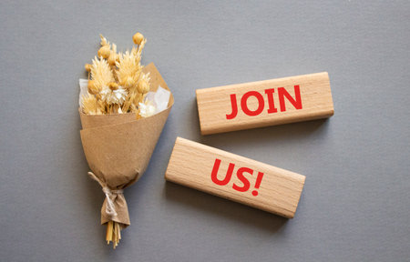 Join us symbol. Concept word Join us on wooden blocks. Beautiful gray background with bouquet of flowers. Business and Join us concept. Copy spaceの写真素材