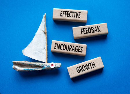 Feedback symbol. Wooden blocks with words Effective Feedback encourages growth. Beautiful blue...