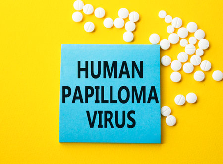 Human Papilloma Virus symbol. Concept word Human Papilloma Virus on blue note. Beautiful yellow background with pills. Medicine and Human Papilloma Virus concept. Copy spaceの写真素材