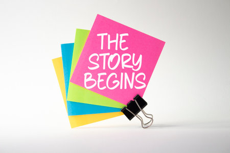 The Story Begins symbol. Sticky notes with words The Story Begins. Beautiful white background. Business and The Story Begins concept. Copy space.の写真素材