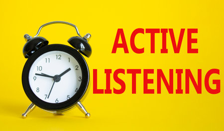 Active listening symbol. Beautiful yellow background with alarm clock. Business and Active listening concept. Copy space.の写真素材