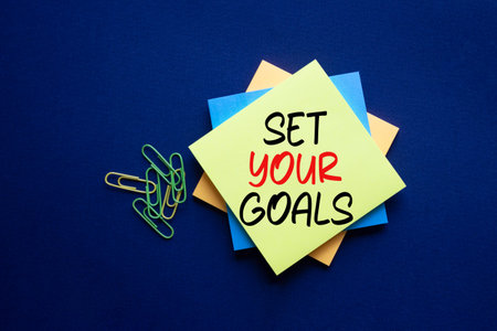 Set your Goals symbol. Sticky notes with Concept words Set your Goals. Beautiful deep blue...