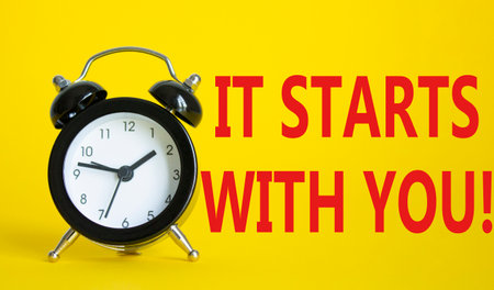 It starts with you symbol. Beautiful yellow background with alarm clock. Business and It starts with you concept. Copy space.の写真素材