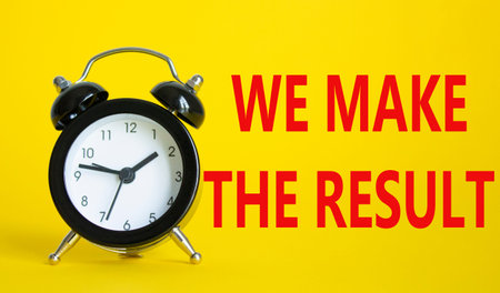 We make the result symbol. Beautiful yellow background with alarm clock with words We make the...