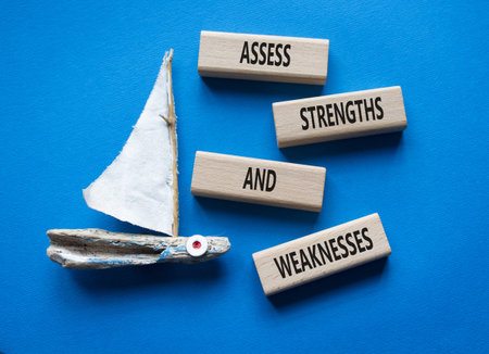 Strengths and Weaknesses symbol. Wooden blocks with words Assess Strengths and Weaknesses. Beautiful...