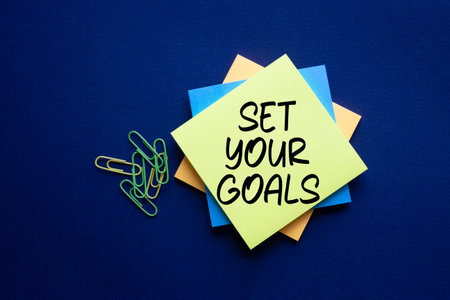 Set your Goals symbol. Sticky notes with Concept words Set your Goals. Beautiful deep blue...