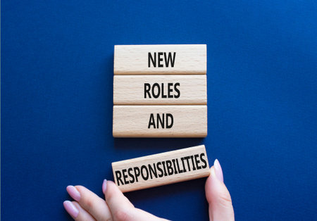 New roles and responsibilities symbol. Wooden blocks with words New roles and responsibilities....