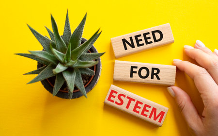 Need for Esteem symbol. Concept words Need for Esteem on wooden blocks. Beautiful yellow background with succulent plant. Businessman hand. Business and Need for Esteem concept. Copy space.の写真素材