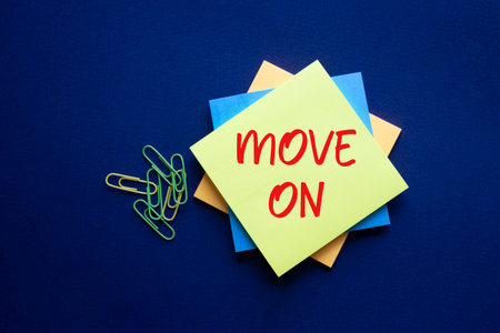 Move on symbol. Yellow sticky note with words Move on. Beautiful deep blue background. Business and Move on concept. Copy space.の写真素材