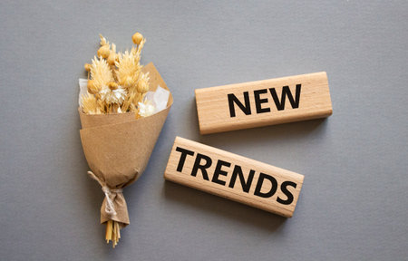 New Trends symbol. Wooden blocks with words New Trends. Beautiful gray background. Business and New Trends concept. Copy space.の写真素材