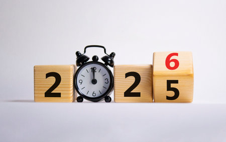 2026 New Year symbol. Businessman turns wooden cube and changes Year 2025 to 2026. Beautiful white...