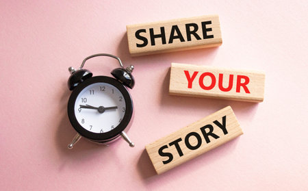 Share your story symbol. Wooden blocks with words Share your story. Beautiful pink background with...