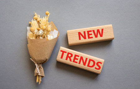 New Trends symbol. Wooden blocks with words New Trends. Beautiful gray background. Business and New Trends concept. Copy space.の写真素材