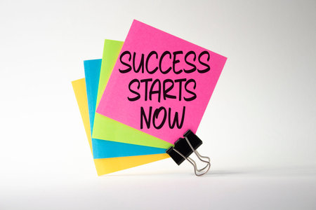 Success Starts Now symbol. Concept words Success Starts Now on sticky notes. Beautiful white...