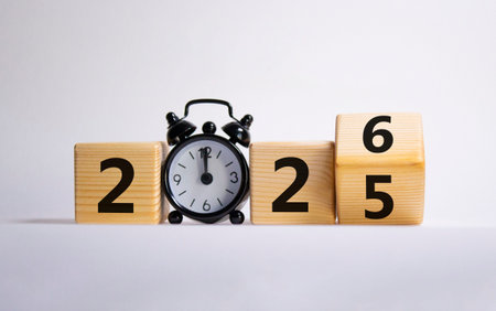 2026 New Year symbol. Businessman turns wooden cube and changes Year 2025 to 2026. Beautiful white...