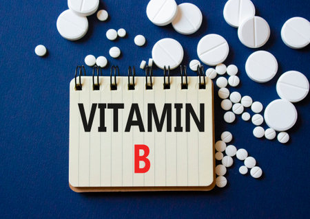 Vitamin B symbol. Concept word Vitamin B on notebook. Beautiful deep blue background with pills. Medicine and Vitamin B concept. Copy spaceの写真素材