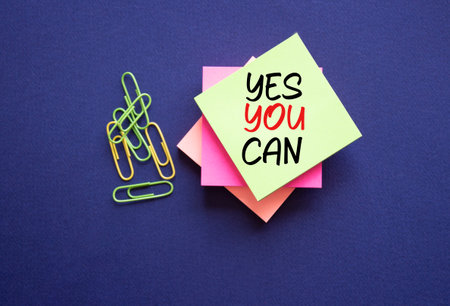 Yes You Can symbol. Concept words Yes You Can on white sticky notes. Beautiful deep blue background. Business and Yes You Can concept. Copy space.の写真素材